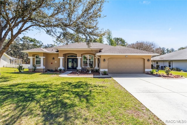 ranch-style house with french doors, stucco siding, an attached garage, a front yard, and driveway