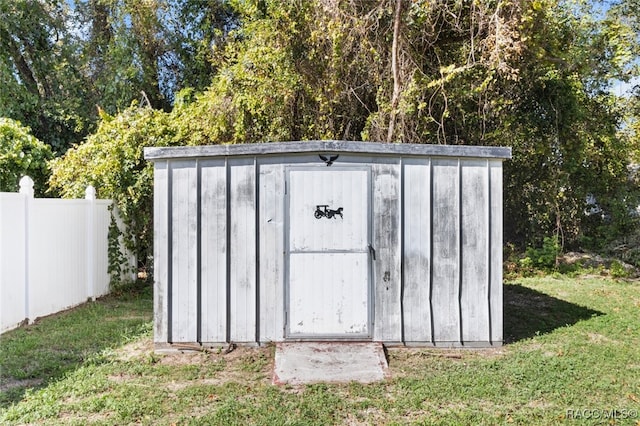 view of outbuilding featuring a lawn