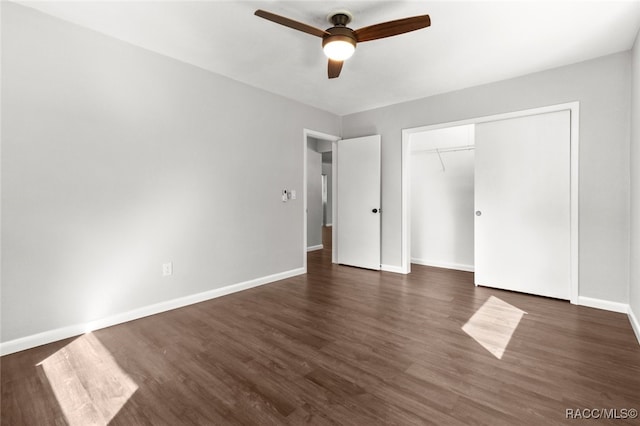 unfurnished bedroom featuring dark hardwood / wood-style floors, ceiling fan, and a closet