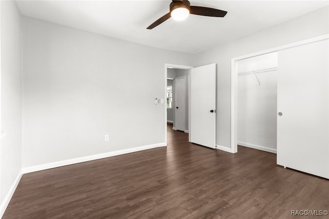 unfurnished bedroom featuring ceiling fan, a closet, and dark wood-type flooring