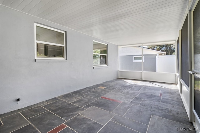 unfurnished sunroom featuring wood ceiling