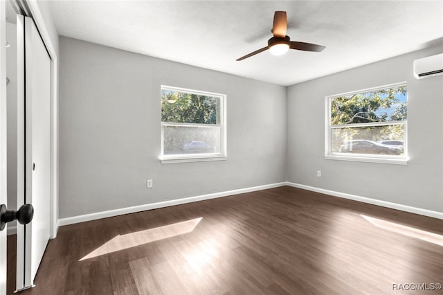 unfurnished bedroom featuring multiple windows, ceiling fan, and dark wood-type flooring