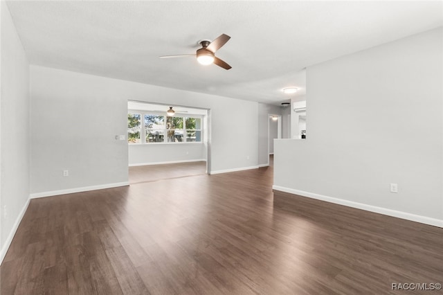 unfurnished living room with dark hardwood / wood-style flooring and ceiling fan