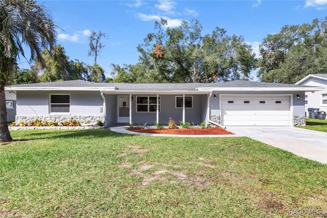 ranch-style house with a garage and a front lawn