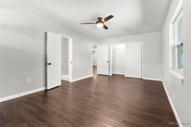 unfurnished bedroom featuring a closet, dark hardwood / wood-style floors, and ceiling fan