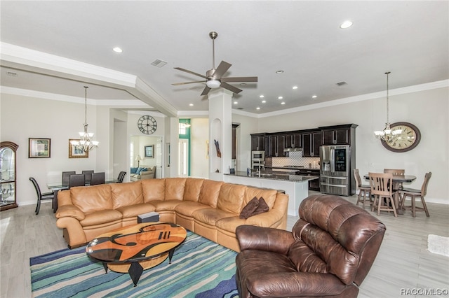 living room featuring crown molding, light hardwood / wood-style floors, and ceiling fan with notable chandelier