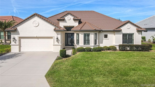 view of front facade with a garage and a front yard