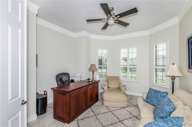 office space featuring light hardwood / wood-style floors, crown molding, and a wealth of natural light