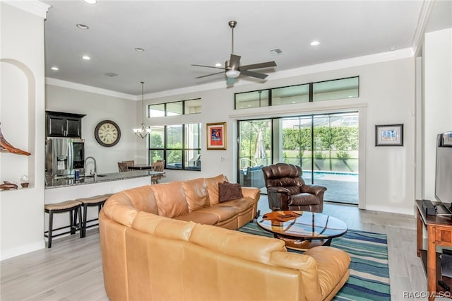 living room with crown molding, sink, ceiling fan, and light hardwood / wood-style floors