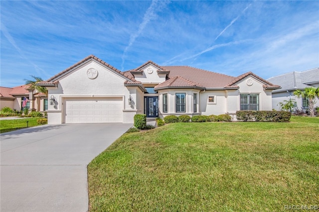 mediterranean / spanish-style home with a front yard and a garage