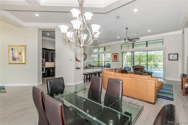 dining area featuring ceiling fan with notable chandelier, light hardwood / wood-style floors, and ornamental molding