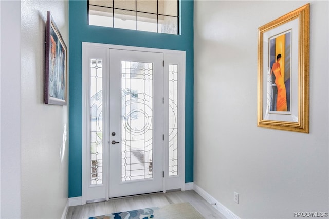 foyer entrance featuring plenty of natural light and light hardwood / wood-style flooring