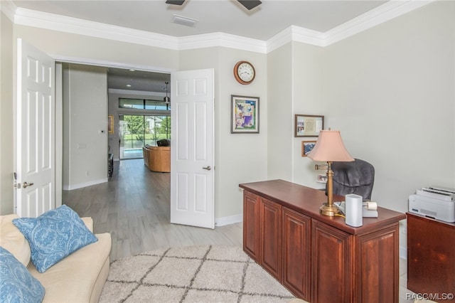 office space featuring light wood-type flooring and crown molding