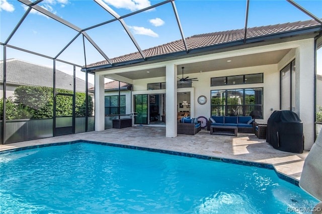 view of pool with ceiling fan, a patio area, an outdoor hangout area, and glass enclosure