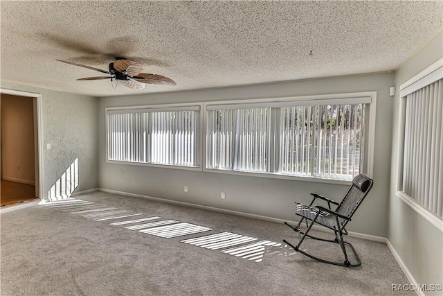 unfurnished sunroom with ceiling fan