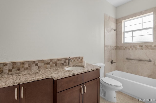 full bathroom with vanity, toilet, and tiled shower / bath combo