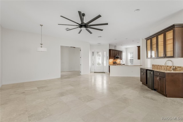 kitchen with sink, pendant lighting, ceiling fan, and dark brown cabinetry