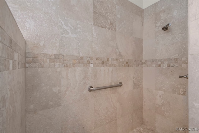 interior details with a tile shower