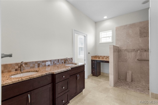 bathroom featuring vanity and a tile shower