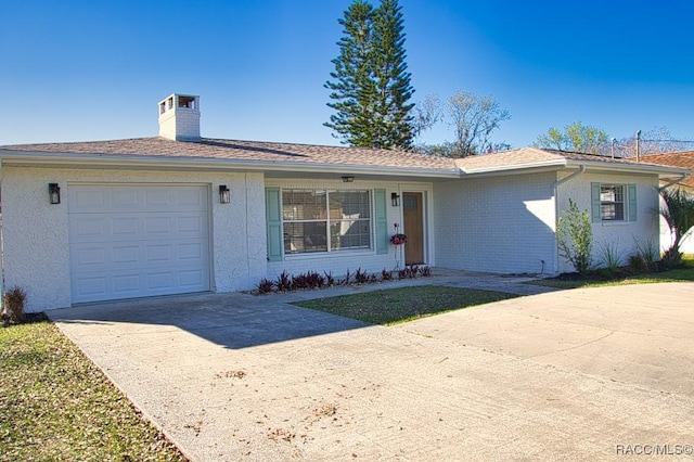 ranch-style home featuring a garage, concrete driveway, brick siding, and a chimney