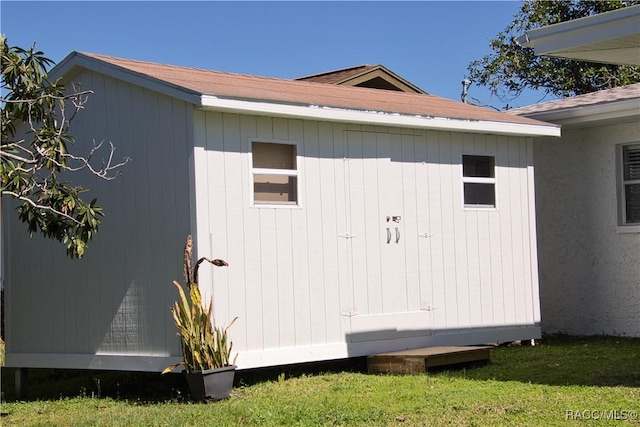 view of outbuilding with a lawn