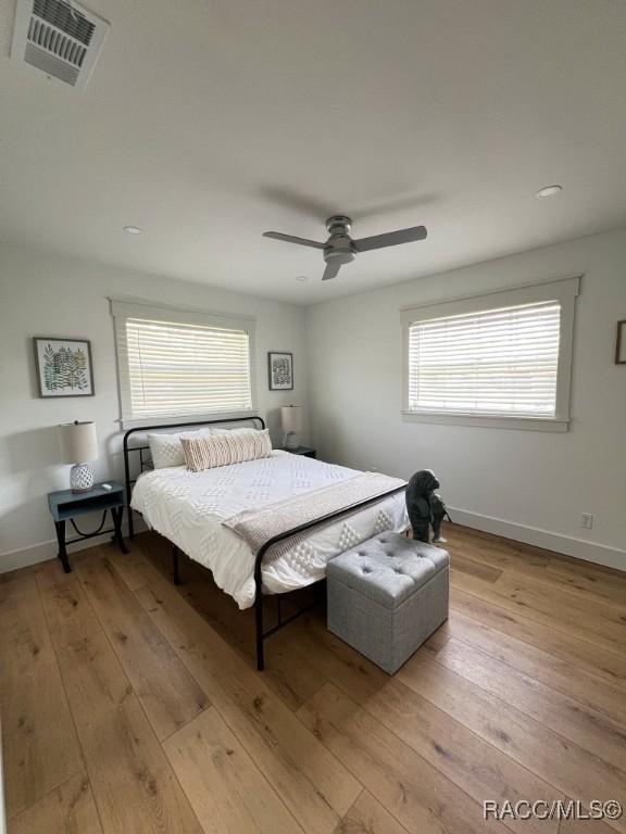 bedroom featuring ceiling fan and light hardwood / wood-style flooring