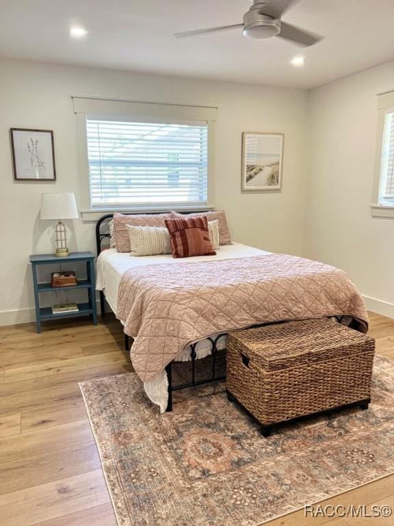 bedroom with ceiling fan and hardwood / wood-style floors