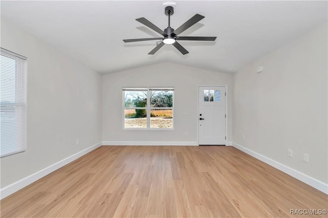 interior space featuring ceiling fan, vaulted ceiling, and light wood-type flooring