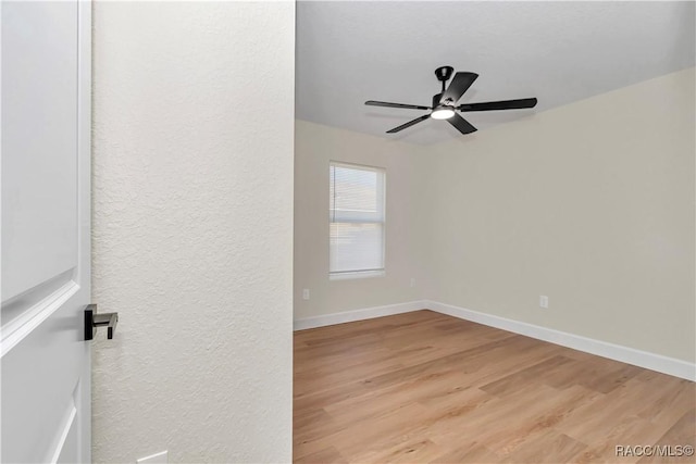 spare room featuring ceiling fan and light hardwood / wood-style floors