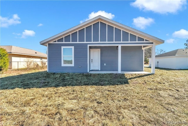 rear view of house with a yard