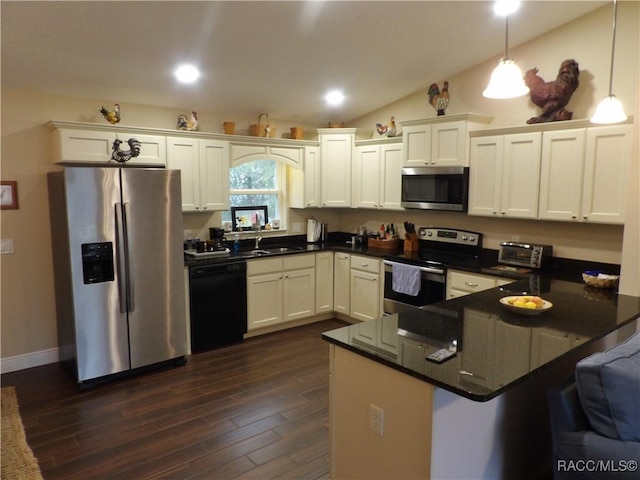 kitchen featuring white cabinetry, dark hardwood / wood-style floors, stainless steel appliances, and decorative light fixtures