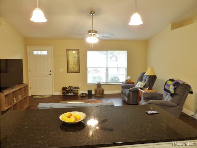 living room featuring ceiling fan, lofted ceiling, and dark hardwood / wood-style flooring