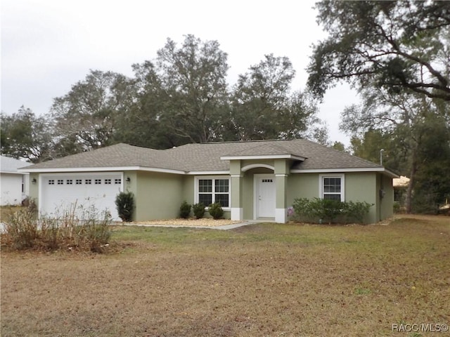 single story home featuring a garage and a front yard