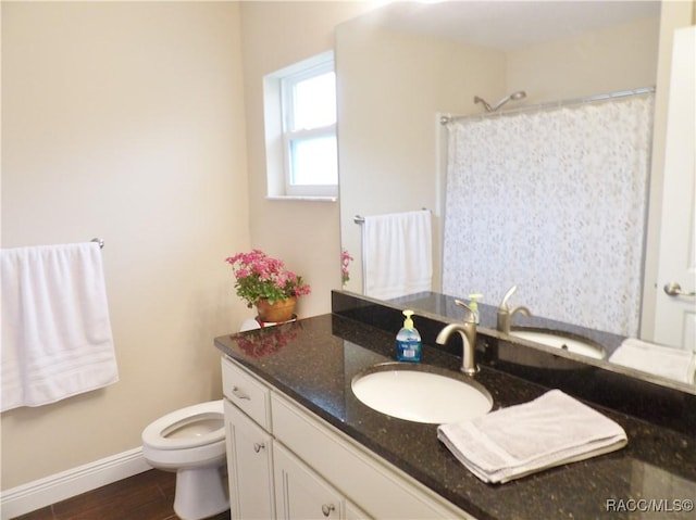 bathroom featuring vanity, wood-type flooring, toilet, and a shower with shower curtain