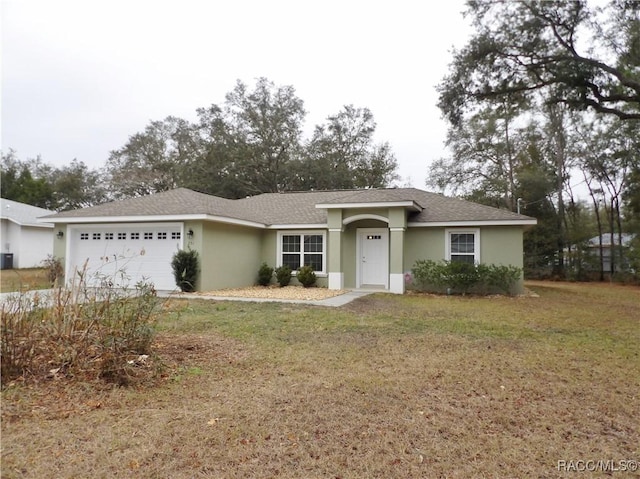 ranch-style house featuring a garage and a front yard