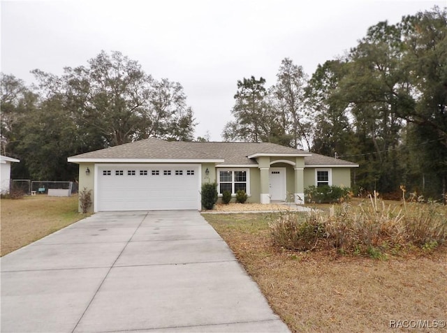 single story home featuring a garage and a front lawn