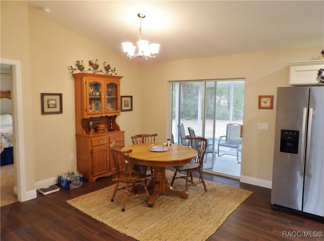 dining room featuring a notable chandelier, vaulted ceiling, and dark hardwood / wood-style floors