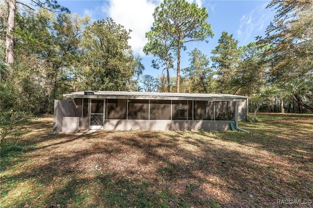 view of outbuilding with a sunroom