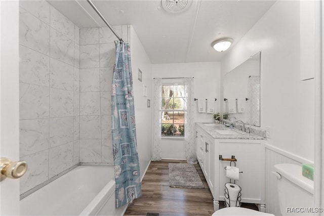 full bathroom with toilet, wood finished floors, visible vents, wainscoting, and shower / tub combo with curtain