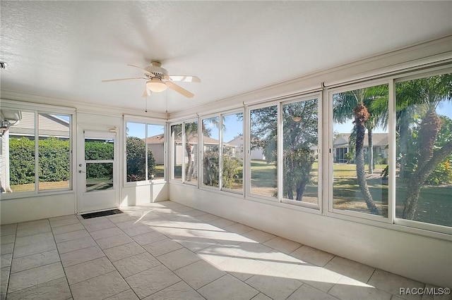 unfurnished sunroom featuring ceiling fan