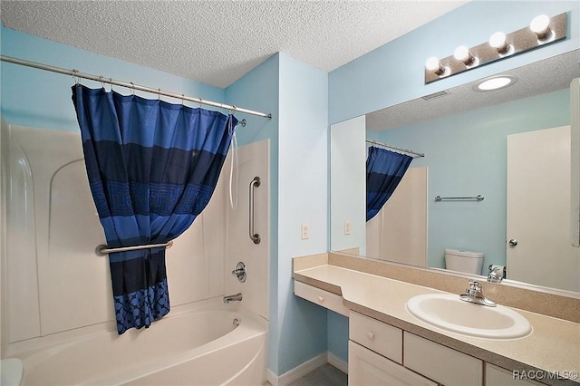 full bathroom featuring vanity, toilet, a textured ceiling, and shower / tub combo