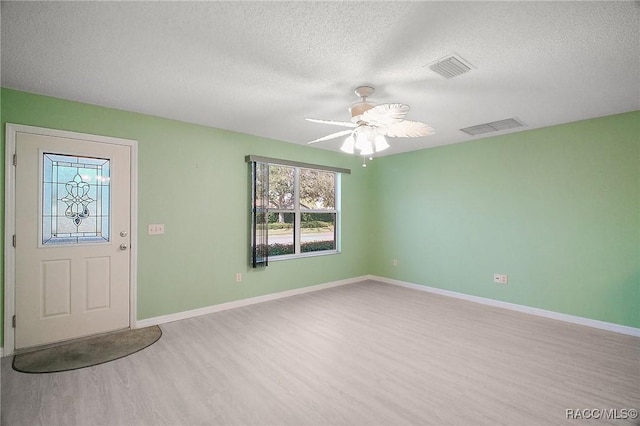 entrance foyer featuring ceiling fan, light wood-type flooring, and a textured ceiling