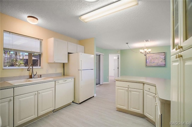 kitchen featuring white cabinets, white appliances, and sink