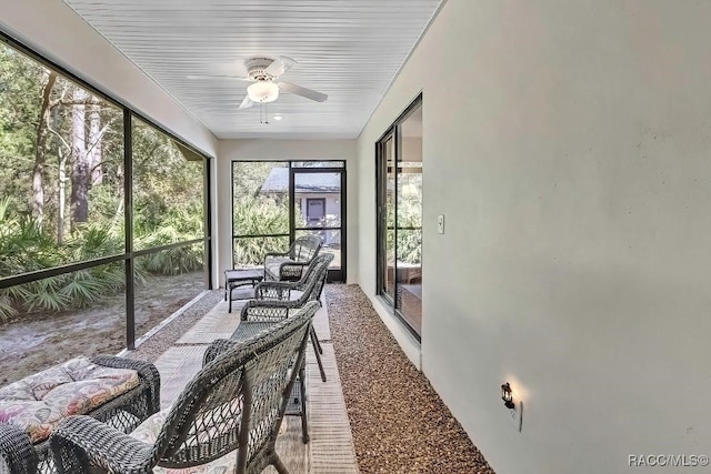 sunroom / solarium featuring ceiling fan