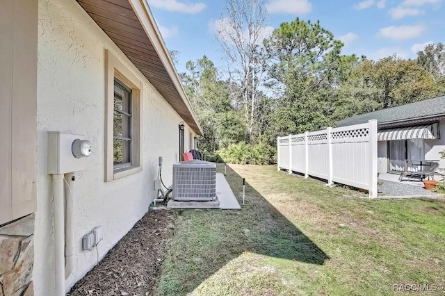 view of yard with cooling unit and a patio