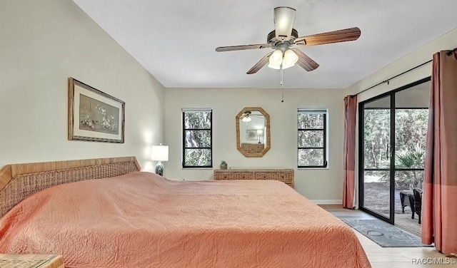 bedroom featuring multiple windows, access to outside, and ceiling fan