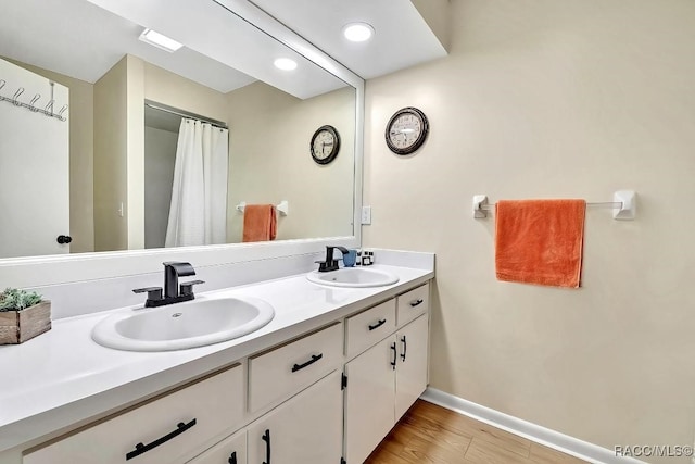 bathroom with hardwood / wood-style flooring and vanity