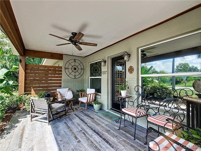 wooden terrace featuring ceiling fan