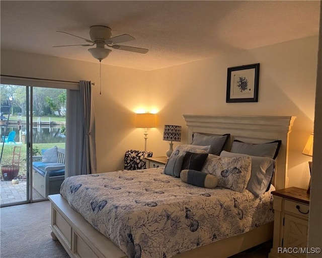 bedroom featuring a textured ceiling, ceiling fan, carpet, and access to exterior