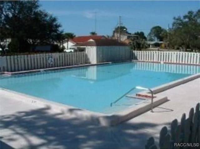 community pool featuring fence